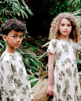 Cinematic shot of Boy and Girl wearing Iguana Print Organic Cotton Sweats and Dress