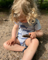 Baby wearing Sustainable Organic Cotton Romper in Blue