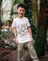 Smiling Boy wearing Unisex Organic Cotton T Shirt with Iguana Print
