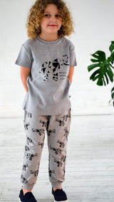 Girl wearing grey unisex organic cotton kid's T shirt and joggers with elephant animal print