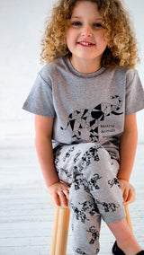 Girl wearing grey unisex organic cotton kid's T shirt and joggers with elephant animal print