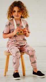Girl wearing pink unisex organic cotton kid's outfit with leopard animal print