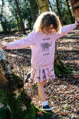 Girl wearing pink unisex organic cotton kid's sweatshirt with leopard animal print