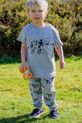 Boy wearing grey unisex organic cotton kid's T shirt and joggers with elephant animal print