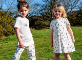 white unisex organic cotton kid's sweatshirt, joggers, and dress with bee animal print