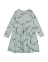Flatlay of organic cotton girl's dress in olive green with crocodile animal print