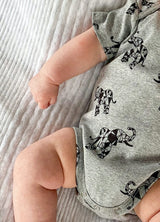 baby wearing grey organic cotton bodysuit romper with elephant animal print