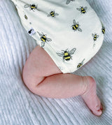mid shot of organic cotton baby sleepsuit with bee animal print