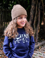Girl wearing navy blue organic cotton unisex sweatshirt with polar bear design