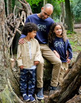 Adult and girl wearing navy blue organic cotton unisex sweatshirt with polar bear design