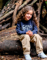 olive Girl wearing navy blue organic cotton unisex sweatshirt with polar bear print