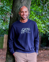 Adult wearing Unisex Organic Cotton Sweater in Navy Blue Animal Print