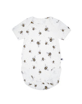 Flatlay of unisex organic cotton baby bodysuit in white with bee animal print