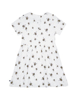 Back flatlay of organic cotton girl's dress in white with bee animal print