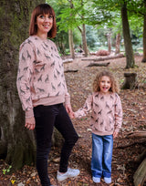 Woman wearing Unisex Organic cotton sweatshirt for Adults in Salmon Pink