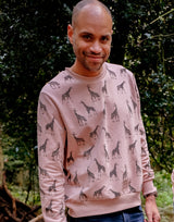 Man wearing Unisex Organic cotton sweatshirt for Adults in Salmon Pink with giraffe pattern