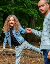 girl wearing olive green unisex children's jogger with crocodile print