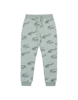 Flatlay of unisex organic cotton kid's joggers in olive green with animal print