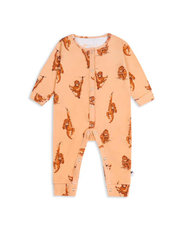 Flat lay of organic cotton orangutan romper for babies, showing full print and snap fastenings on a white background