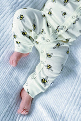 close up of white organic cotton bodysuit romper with bee animal print